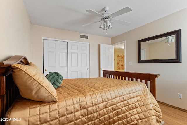 bedroom featuring ceiling fan, a closet, and light hardwood / wood-style floors