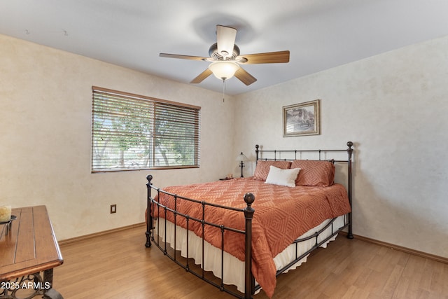 bedroom featuring ceiling fan and light hardwood / wood-style flooring