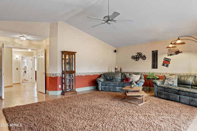 living room featuring ceiling fan and lofted ceiling