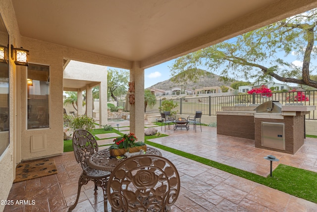 view of patio featuring area for grilling and a fire pit