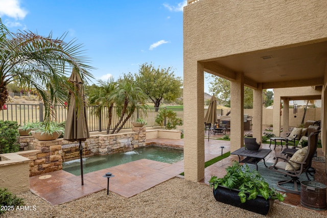 view of patio / terrace featuring pool water feature and a hot tub