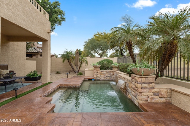 view of pool featuring pool water feature and a patio area