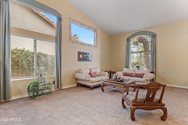 living room with light colored carpet and vaulted ceiling