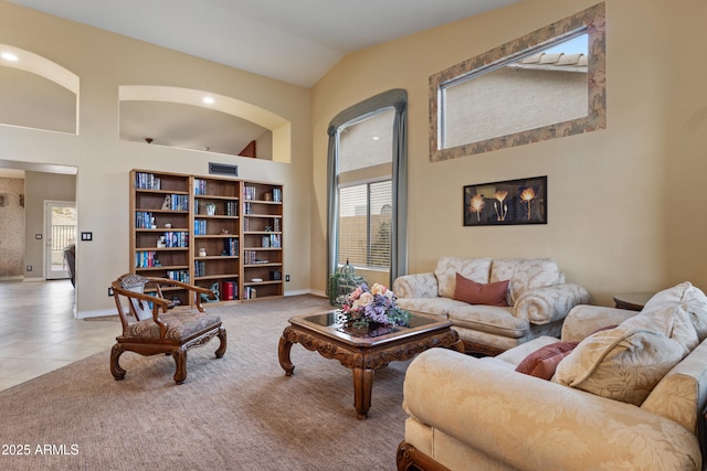 living room with light tile patterned flooring and vaulted ceiling