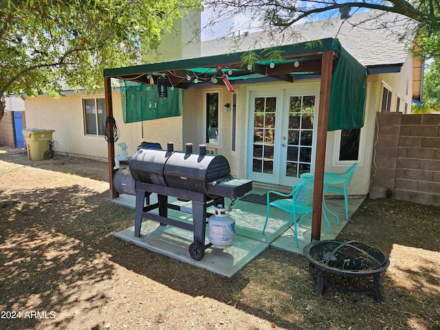 back of property featuring a fire pit, french doors, and a patio area