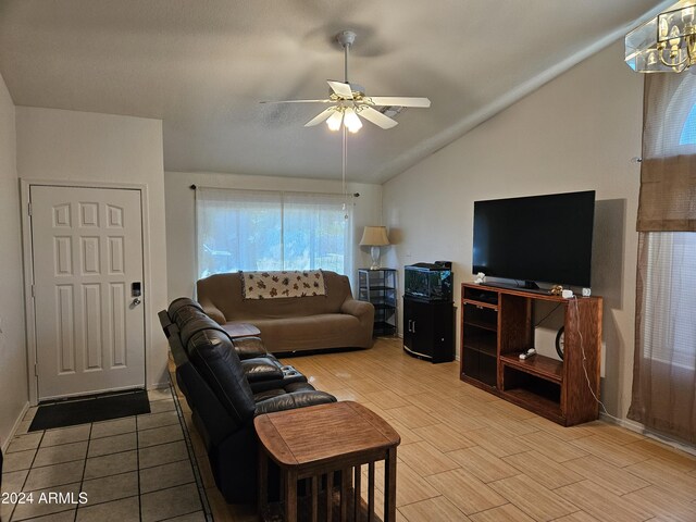 living room with ceiling fan, a textured ceiling, and light hardwood / wood-style flooring