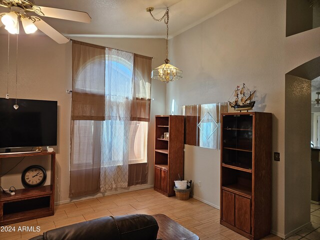 living room featuring wood-type flooring, ceiling fan, and vaulted ceiling