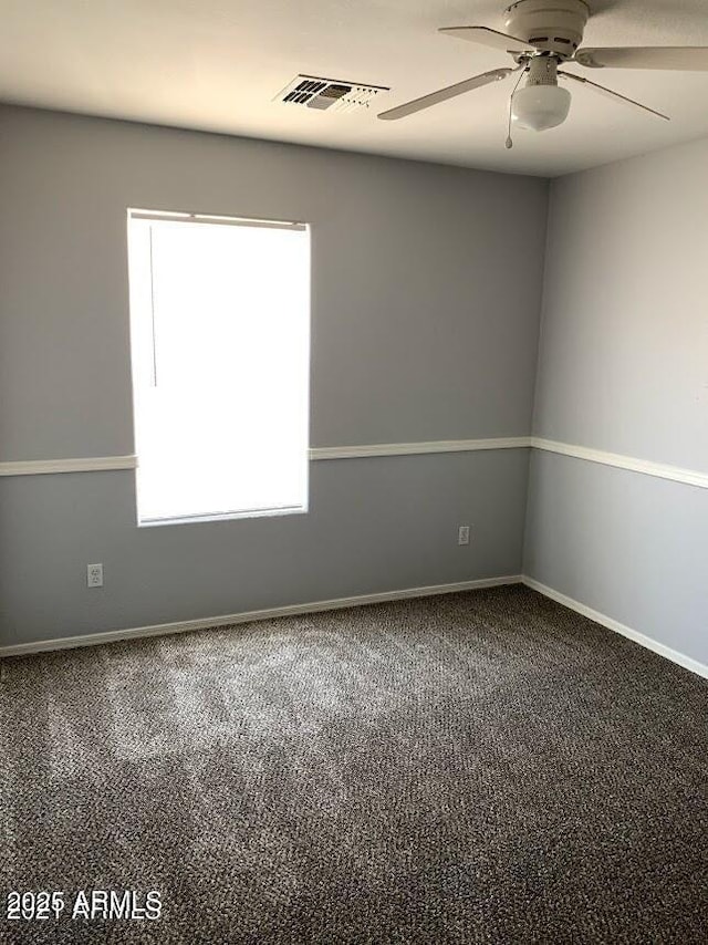 empty room with ceiling fan and carpet