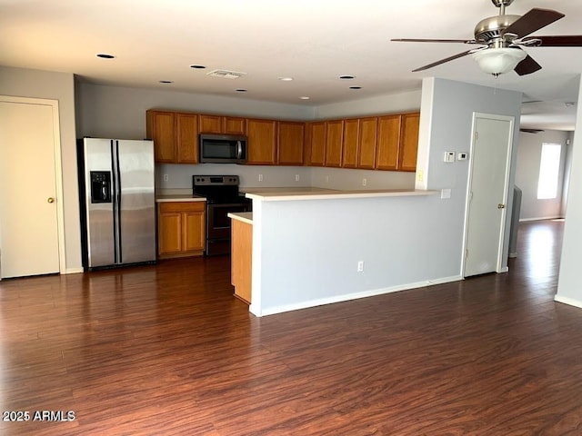 kitchen with dark wood-type flooring, stainless steel appliances, and ceiling fan