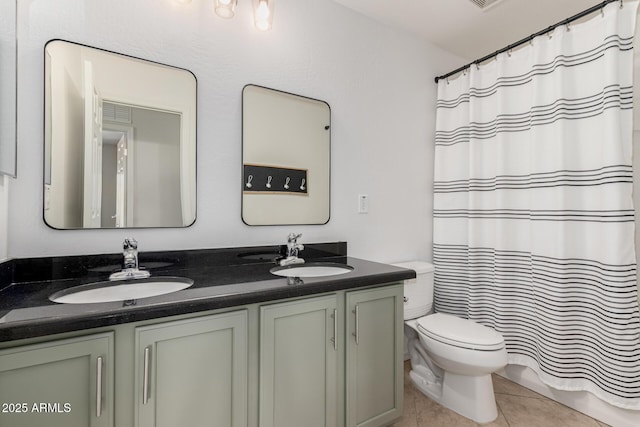 bathroom with vanity, tile patterned floors, and toilet