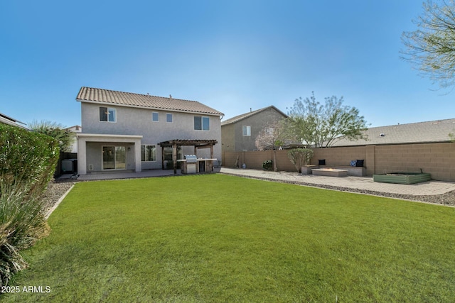 back of house with a pergola, a patio area, and a lawn