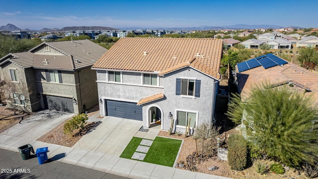 view of front of house featuring a garage and a mountain view