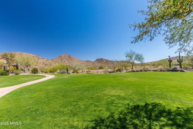 exterior space with a yard and a mountain view