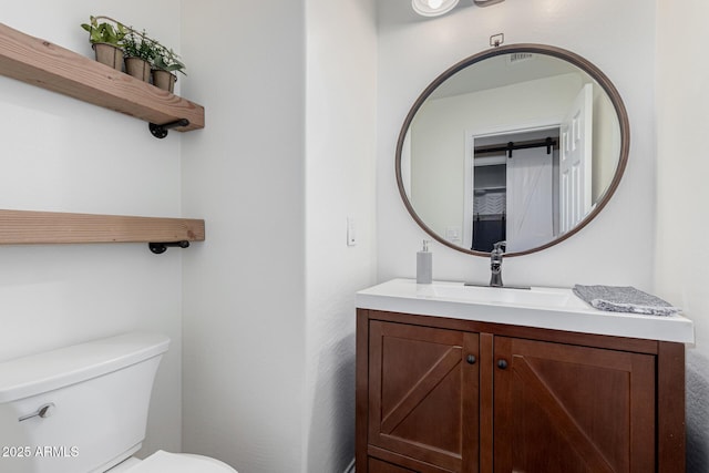 bathroom with vanity and toilet