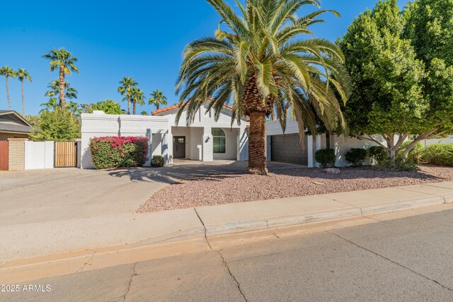 6220 E Paradise Ln, Scottsdale, AZ 85254 - view of front facade featuring concrete driveway, a gate, stucco siding, an attached garage, and fence