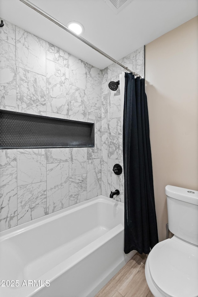 6220 E Paradise Ln, Scottsdale, AZ 85254 - full bath featuring toilet, shower / bath combo with shower curtain, and wood finished floors