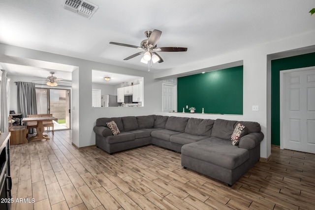 3438 S Bowman Rd, Apache Junction, AZ 85119 - living area with ceiling fan and light wood-style floors