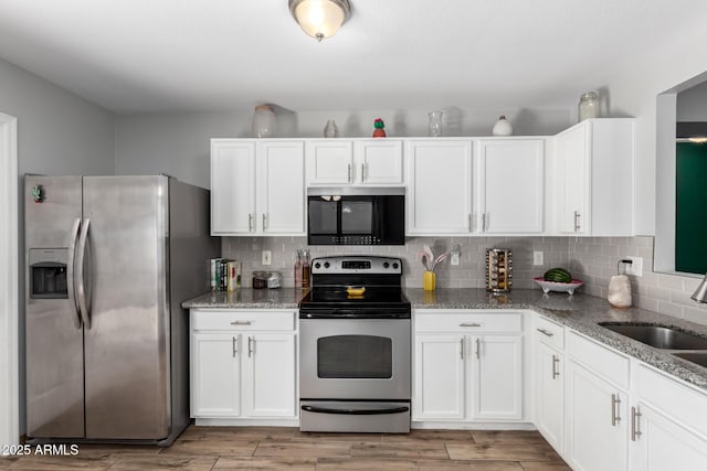 3438 S Bowman Rd, Apache Junction, AZ 85119 - kitchen featuring appliances with stainless steel finishes, light stone countertops, white cabinetry, tasteful backsplash, and light wood finished floors