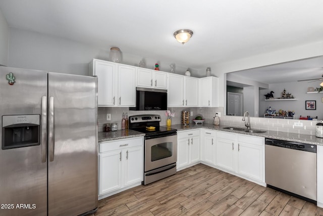3438 S Bowman Rd, Apache Junction, AZ 85119 - kitchen with appliances with stainless steel finishes, decorative backsplash, white cabinets, and light wood-type flooring