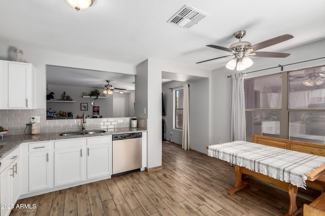 3438 S Bowman Rd, Apache Junction, AZ 85119 - kitchen featuring stainless steel dishwasher, ceiling fan, tasteful backsplash, light stone counters, and white cabinets