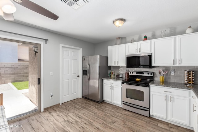 3438 S Bowman Rd, Apache Junction, AZ 85119 - kitchen with appliances with stainless steel finishes, backsplash, white cabinetry, light wood finished floors, and dark stone countertops