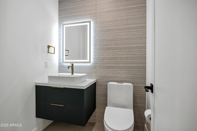 bathroom featuring toilet and vanity