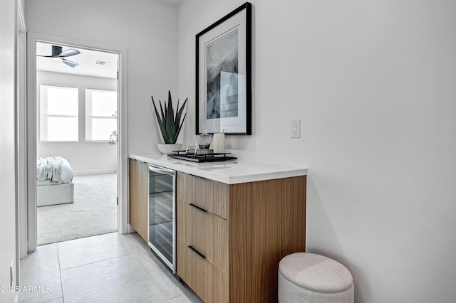 interior space featuring tile patterned floors, vanity, and wine cooler