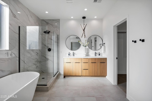 bathroom with vanity and independent shower and bath