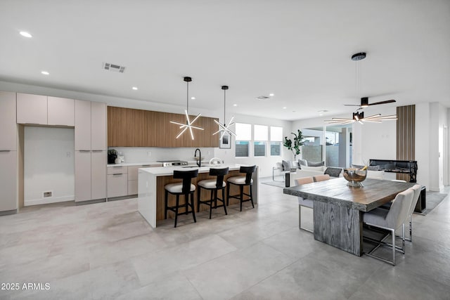 dining area featuring ceiling fan and sink