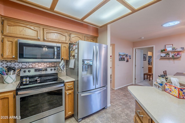 8160 E Keats Ave Unit 364, Mesa, AZ 85209 - kitchen with appliances with stainless steel finishes, light countertops, tasteful backsplash, and brown cabinetry