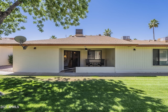 8160 E Keats Ave Unit 364, Mesa, AZ 85209 - back of house with a lawn, a ceiling fan, a patio area, roof with shingles, and central AC unit
