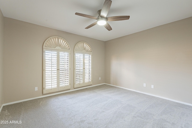 unfurnished room with ceiling fan and light carpet