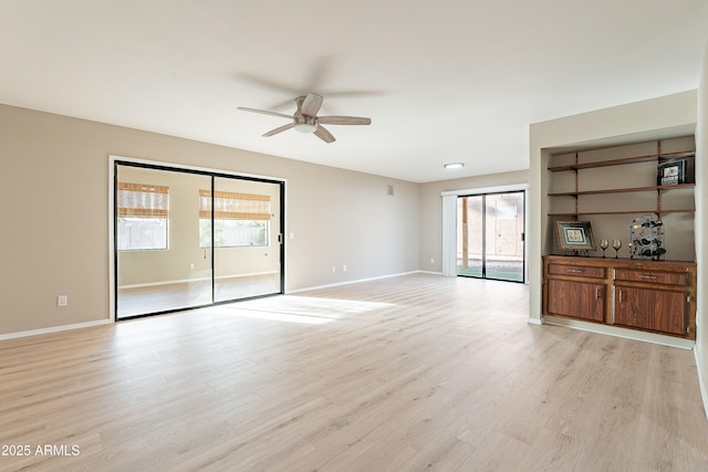 unfurnished living room featuring ceiling fan and light hardwood / wood-style floors