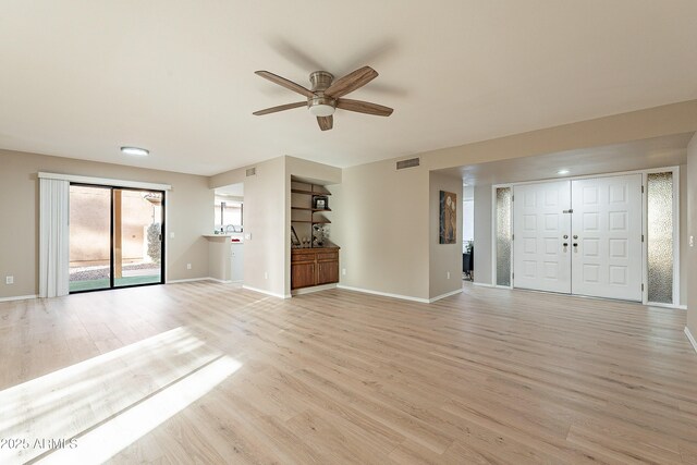 unfurnished living room featuring ceiling fan and light hardwood / wood-style flooring