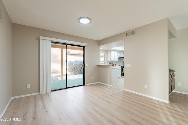 unfurnished room with light hardwood / wood-style floors