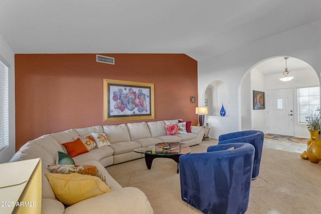 living room featuring light carpet and lofted ceiling