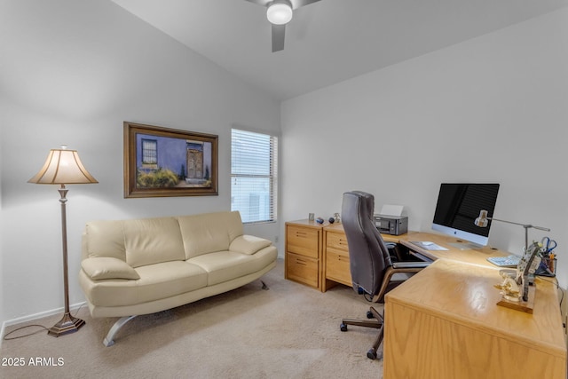 office space featuring vaulted ceiling, light carpet, and ceiling fan