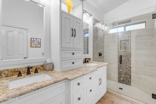 bathroom featuring a shower with door, vanity, and lofted ceiling