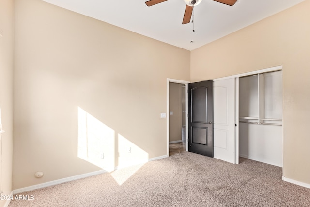 unfurnished bedroom with a closet, ceiling fan, and light carpet