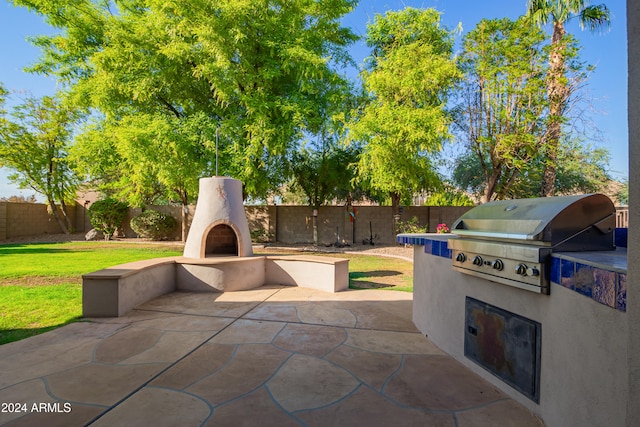 view of patio featuring grilling area and exterior kitchen