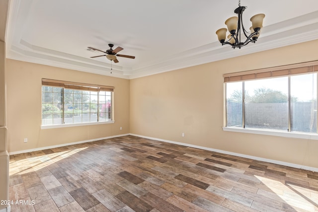 unfurnished room with ornamental molding, a raised ceiling, hardwood / wood-style flooring, and plenty of natural light