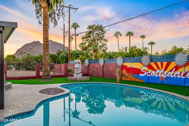 view of swimming pool featuring fence, a fenced in pool, and a mountain view