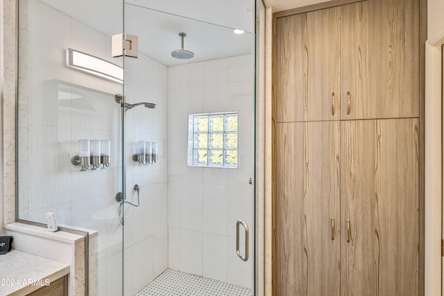 bathroom featuring vanity and a shower with shower door