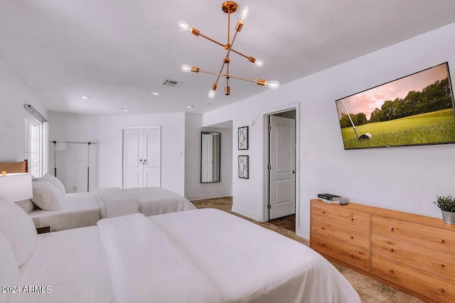 bedroom with visible vents and a notable chandelier