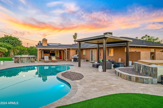 pool at dusk with an outdoor living space, a grill, and a patio