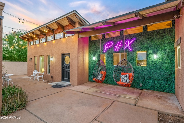 exterior space featuring a patio and stucco siding