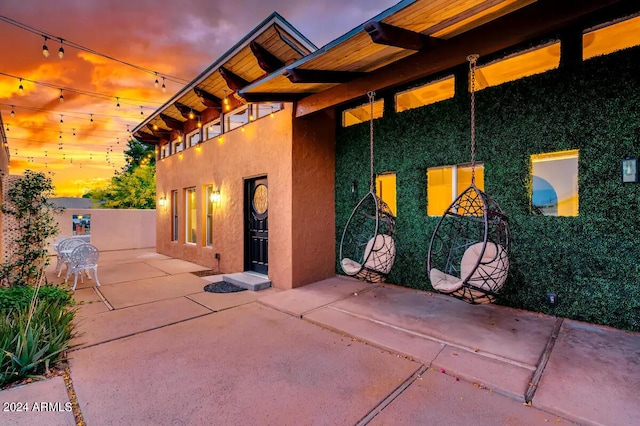 view of patio terrace at dusk