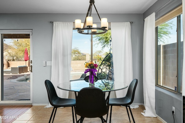 tiled dining area featuring a chandelier