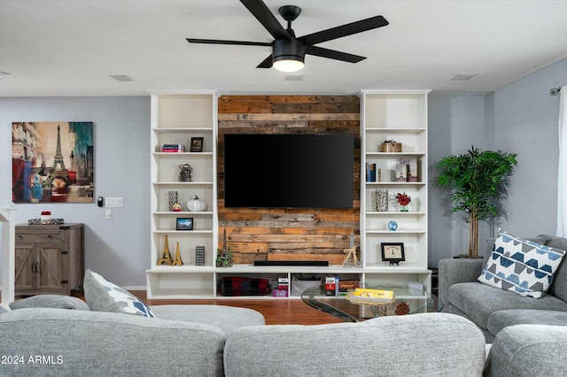 living room featuring wood-type flooring and ceiling fan