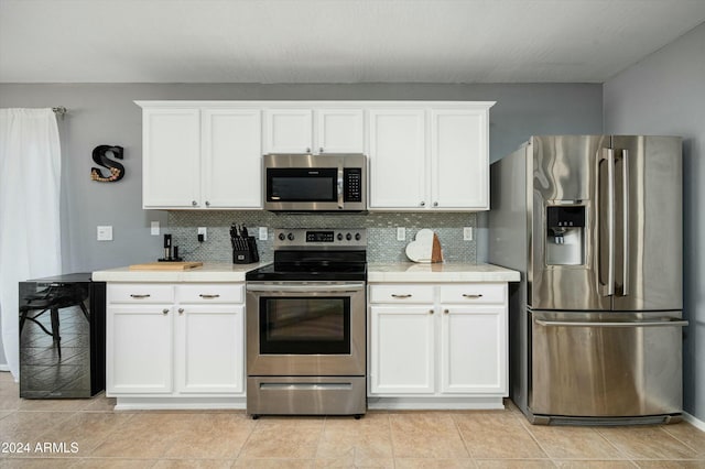 kitchen with wine cooler, decorative backsplash, white cabinets, and appliances with stainless steel finishes